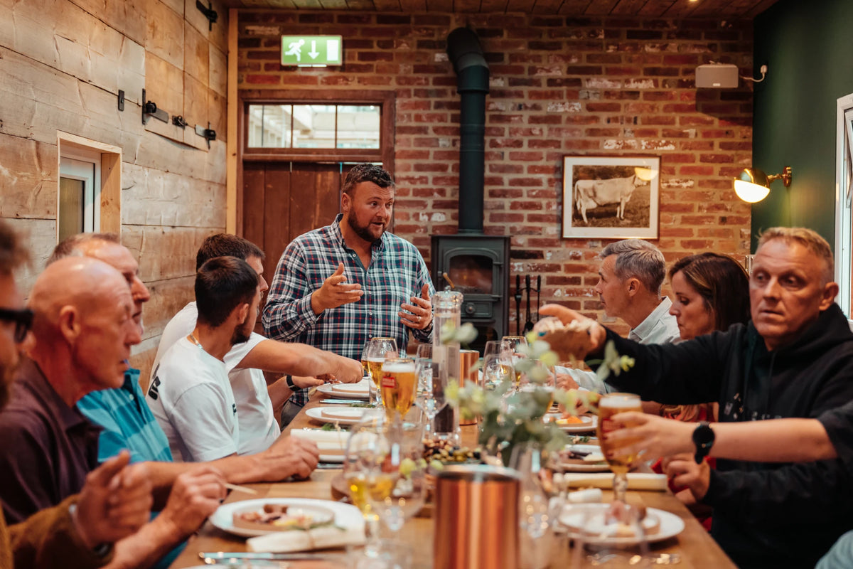 A group enjoying dinner round the long oak table