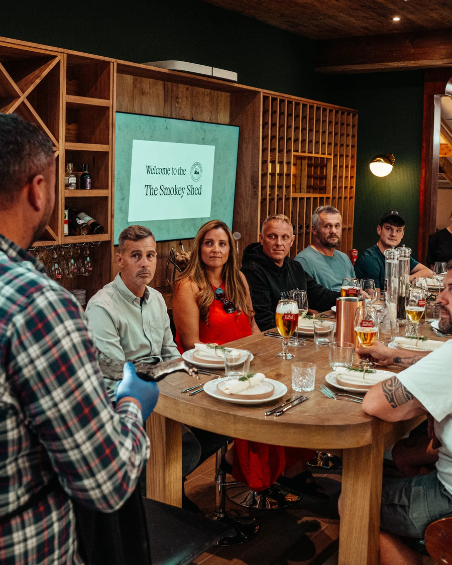 A team gathered round the table in front of the big screen