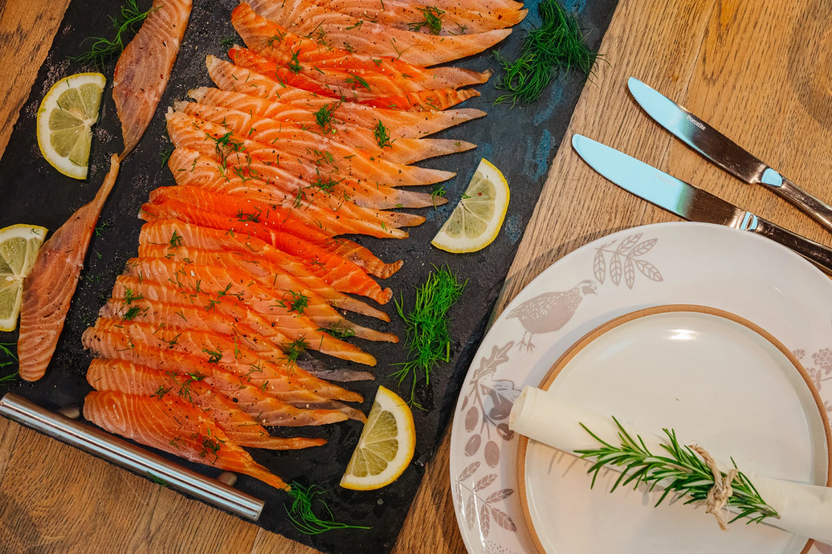 Smoked salmon on slate with lemon and dill