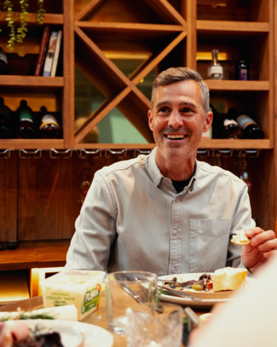 A guest smiling at the table over dinner